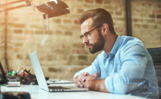 Traveller with suitcase at airport window, representing new journeys and global opportunities with Berlitz.