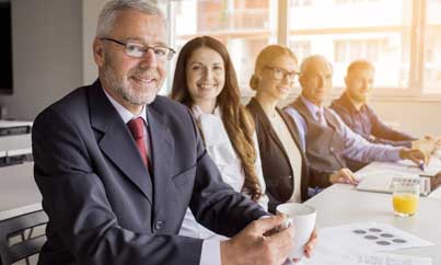 Colleagues looking at a sticky-note board